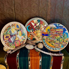 Three lazy susans made from wood with different painted designs.