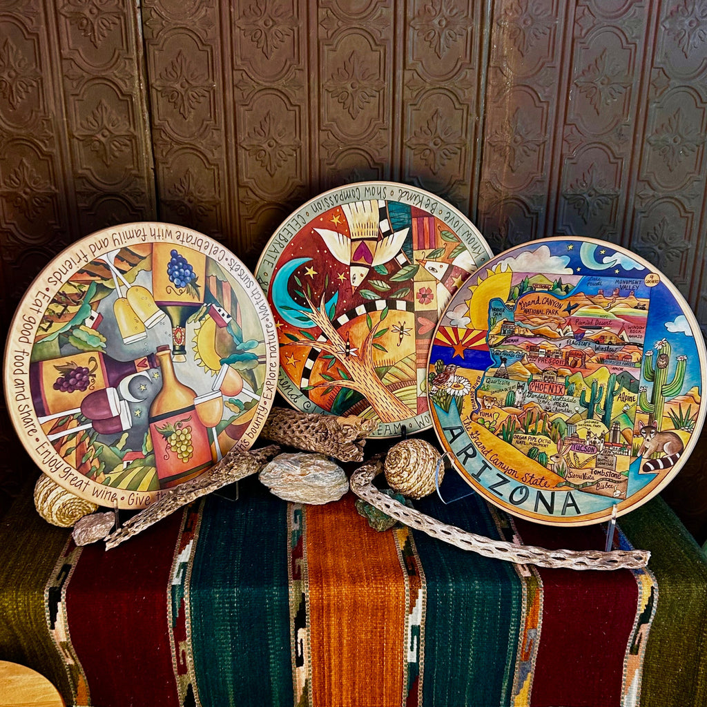 Three lazy susans made from wood with different painted designs.