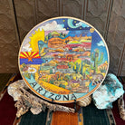 Wooden lazy susan with decorative designs such as with Arizona state colored in with various desert motifs in vibrant colors.