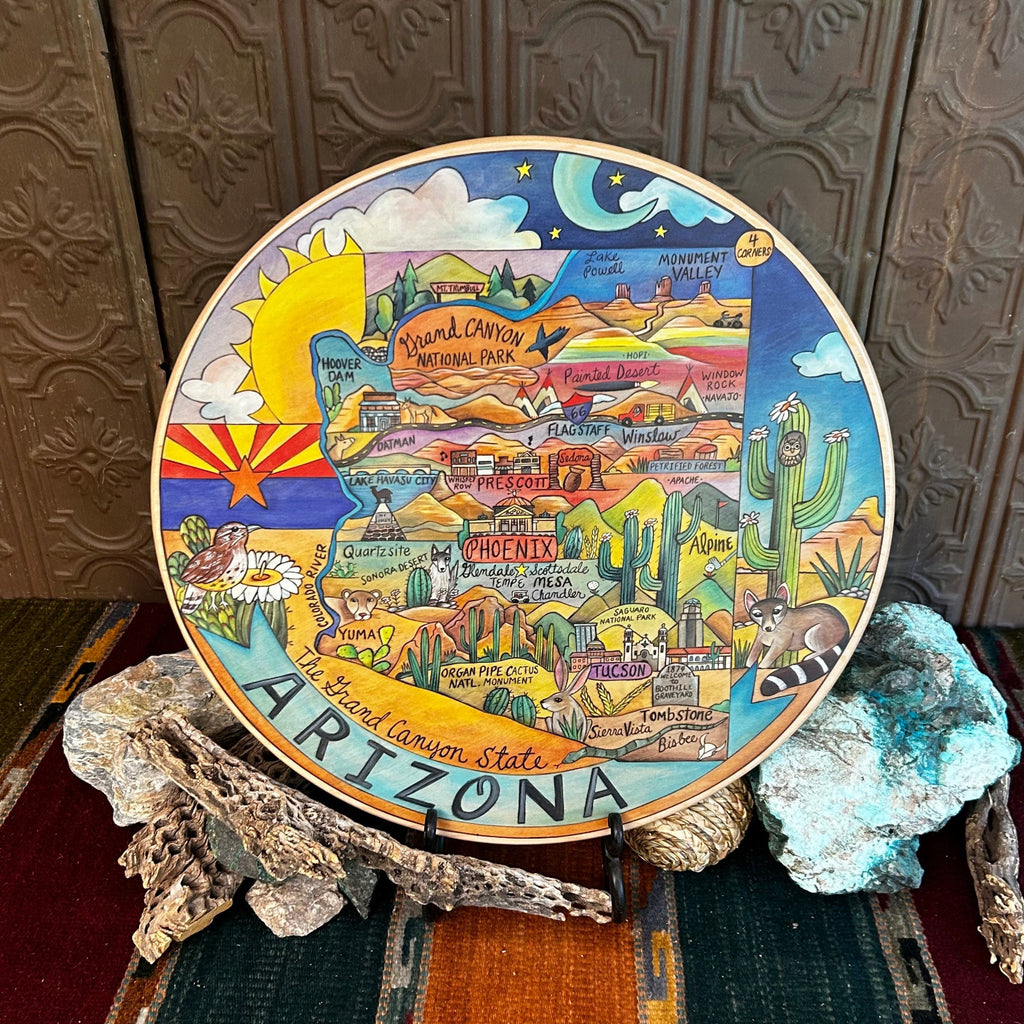 Wooden lazy susan with decorative designs such as with Arizona state colored in with various desert motifs in vibrant colors.