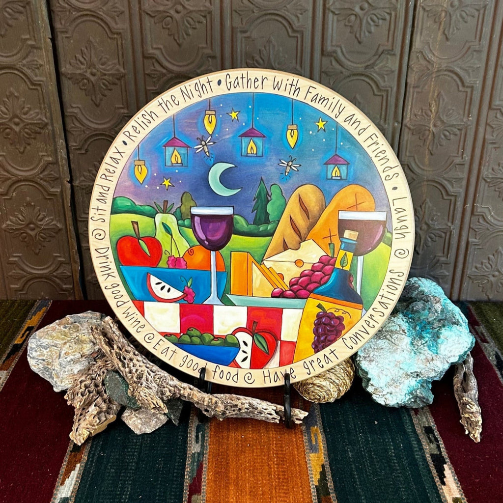 Wooden lazy susan with decorative designs such as fireflies, cheese, fruit and more in vibrant colors.