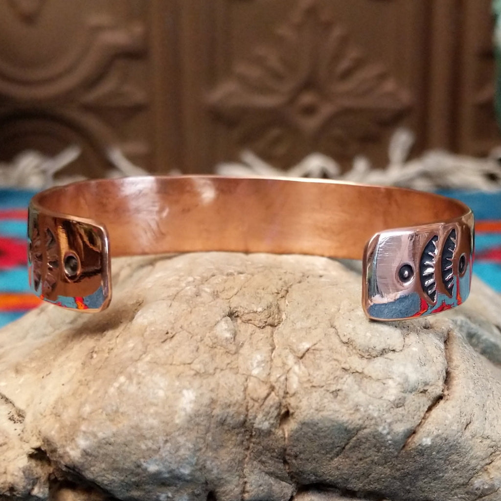 Copper and silver cuff with leaf-like stamping.