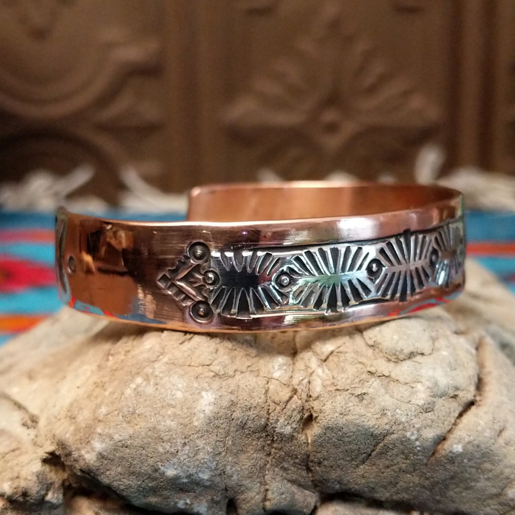 Copper and silver cuff with leaf-like stamping.
