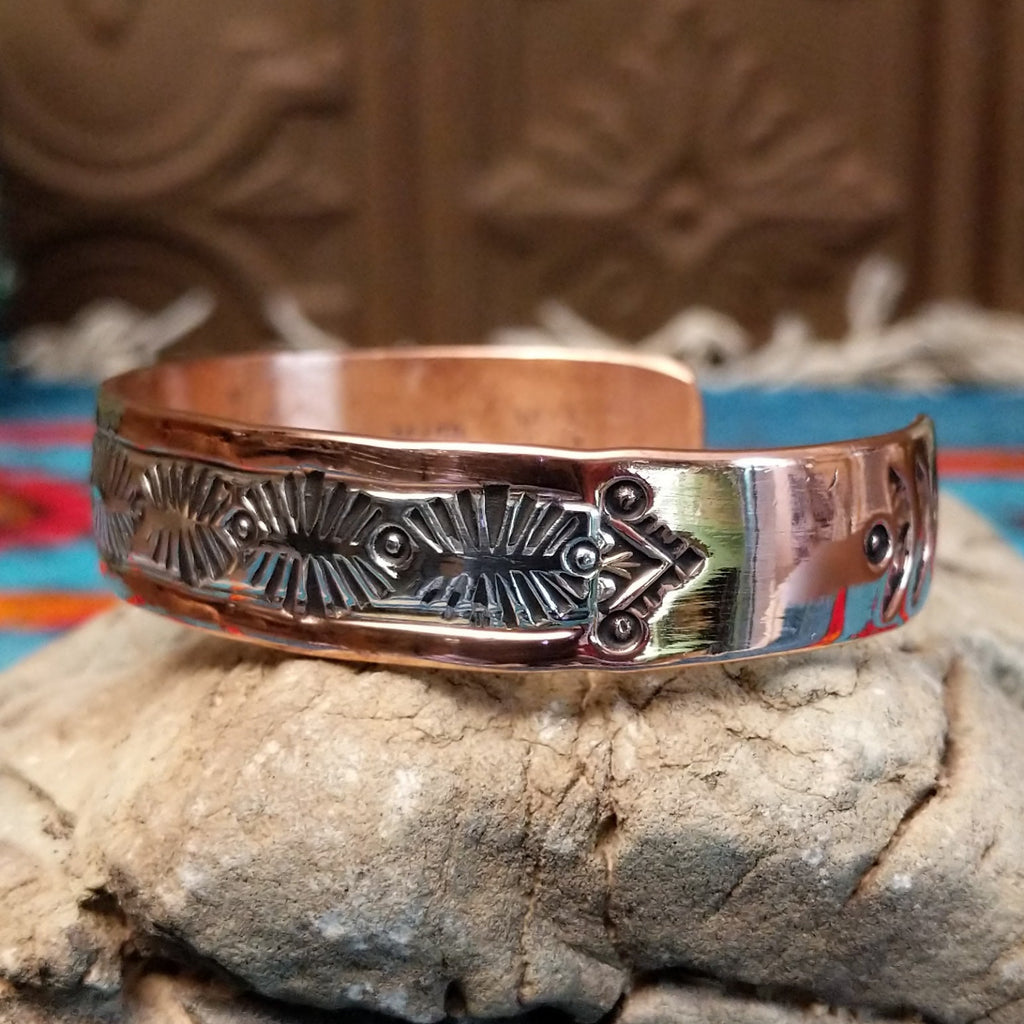Copper and silver cuff with leaf-like stamping.