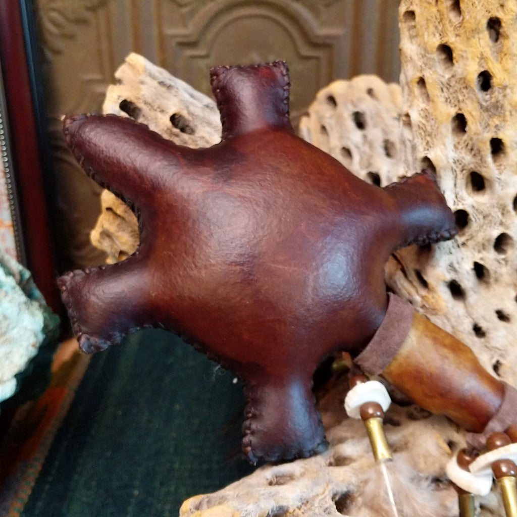 Close-up of the brown, leather turtle rattle.