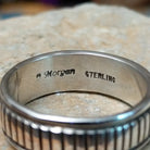 Sterling silver band ring by Bruce Morgan with hand-stamped linear detailing; artisan and Sterling Silver stamp.