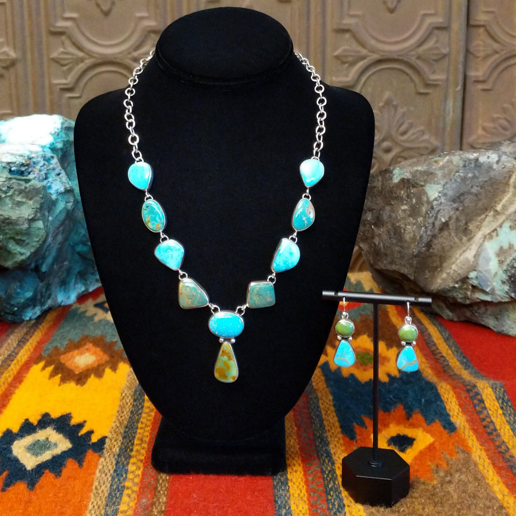 Turquoise necklace linked on a sterling silver chain with alternating green and blue turquoise stones and matching earrings.