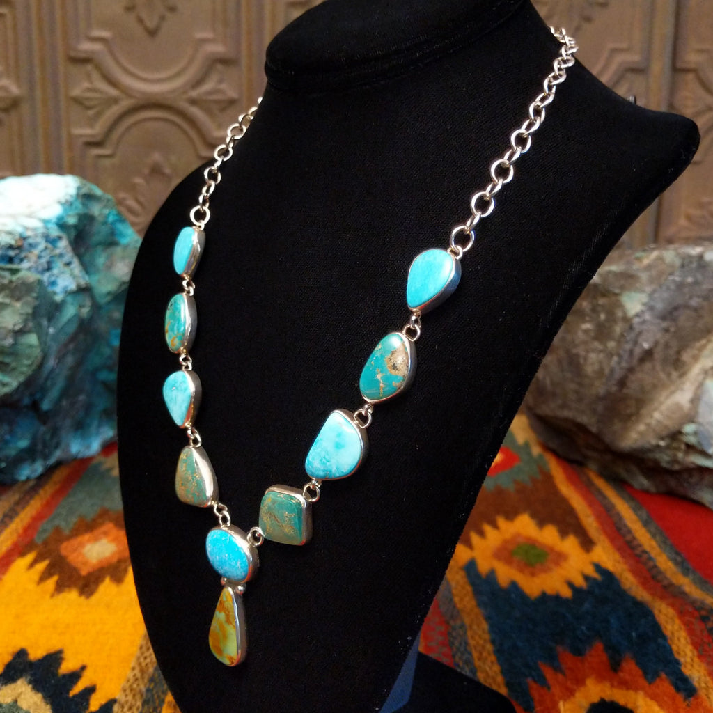 Turquoise necklace linked on a sterling silver chain with alternating green and blue turquoise stones.