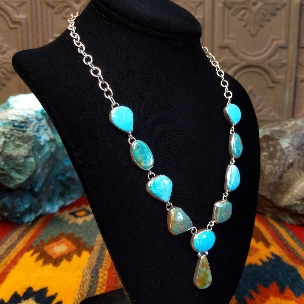 Turquoise necklace linked on a sterling silver chain with alternating green and blue turquoise stones.