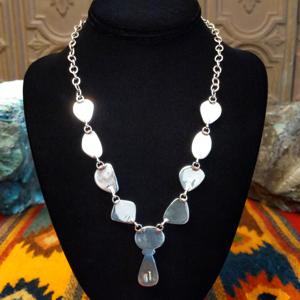 Polished sterling silver of the pendants on the back side of the necklace.