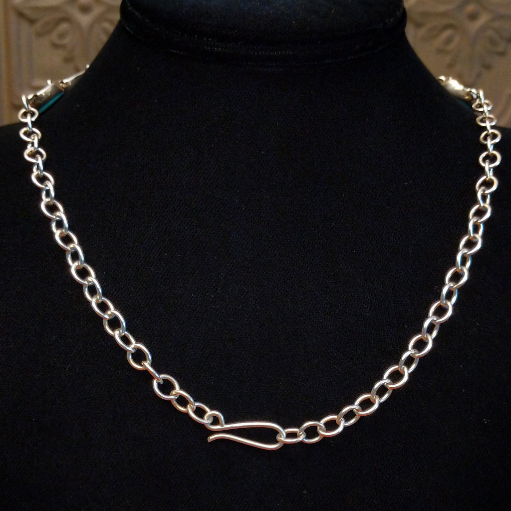 A hook clasp on the chain making it semi-adjustable.