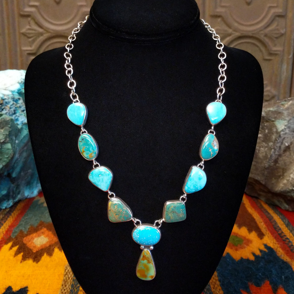 Turquoise necklace linked on a sterling silver chain with alternating green and blue turquoise stones.