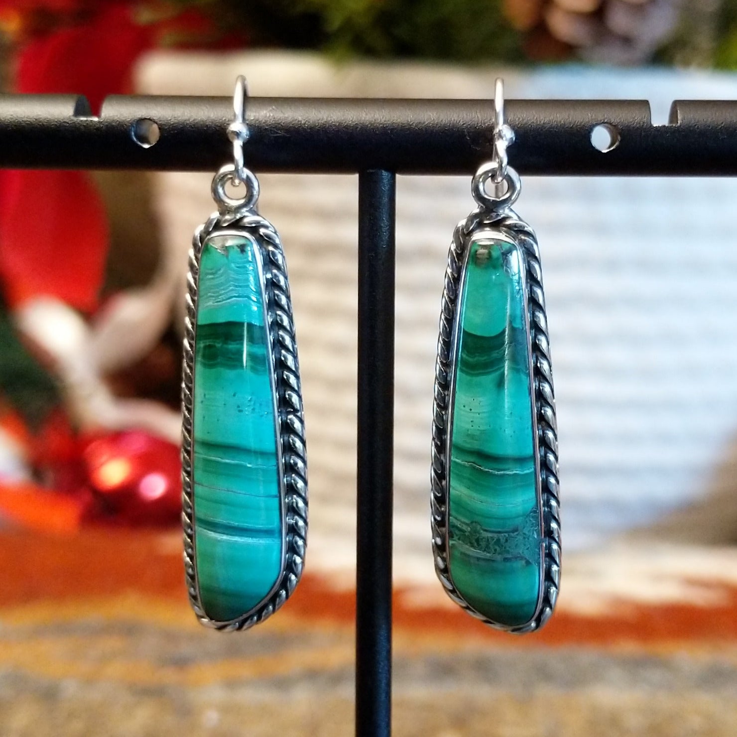 Long malachite earrings set in sterling silver bezels with twisted rope accents.