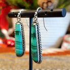 Long malachite earrings set in sterling silver bezels with twisted rope accents.