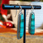 Long malachite earrings set in sterling silver bezels with twisted rope accents.