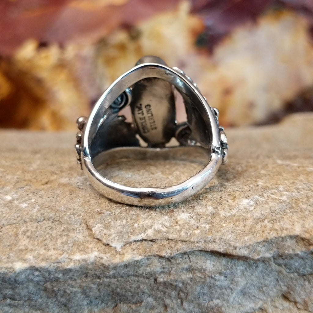 The tapered, thin band in sterling silver of the ring.
