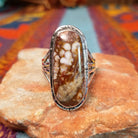 Long Oval Wild Horse Ring by John King featuring a large Wild Horse stone with brown, rust, cream, and white matrix set in Sterling Silver with detailed silverwork and a split-shank band.