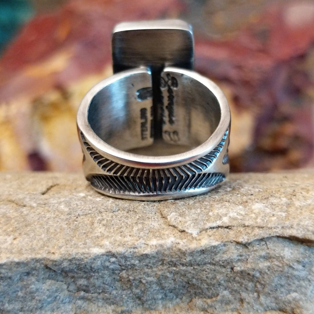 The band is intricately stamped with various designs.