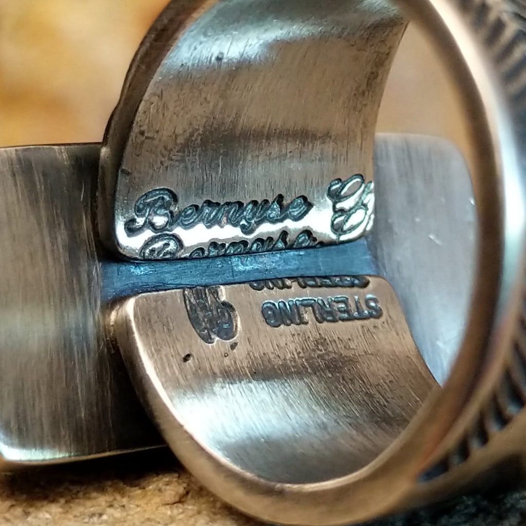 The artisan's signature is found on the underside of the band.