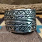 Longhorn stamped sterling silver cuff by E. Piaso, featuring bold geometric hand-stamped longhorn-inspired patterns on a handcrafted wide sterling silver open cuff.