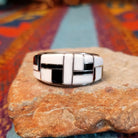 Magnesite & Black Onyx Ring by Karen Skeet featuring geometric white magnesite and black onyx inlay separated by fine silver channels across a wide polished silver band.