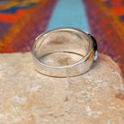 Magnesite & Black Onyx Ring by Karen Skeet featuring geometric white magnesite and black onyx inlay separated by fine silver channels across a wide polished silver band; underside view.