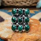 Handcrafted sterling silver malachite cluster ring by Gilo & Grace Nakai, featuring nine oval malachite gemstones with natural green banding.