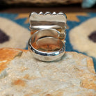 Handcrafted sterling silver malachite cluster ring by Gilo & Grace Nakai, featuring nine oval malachite gemstones with natural green banding; underside view.