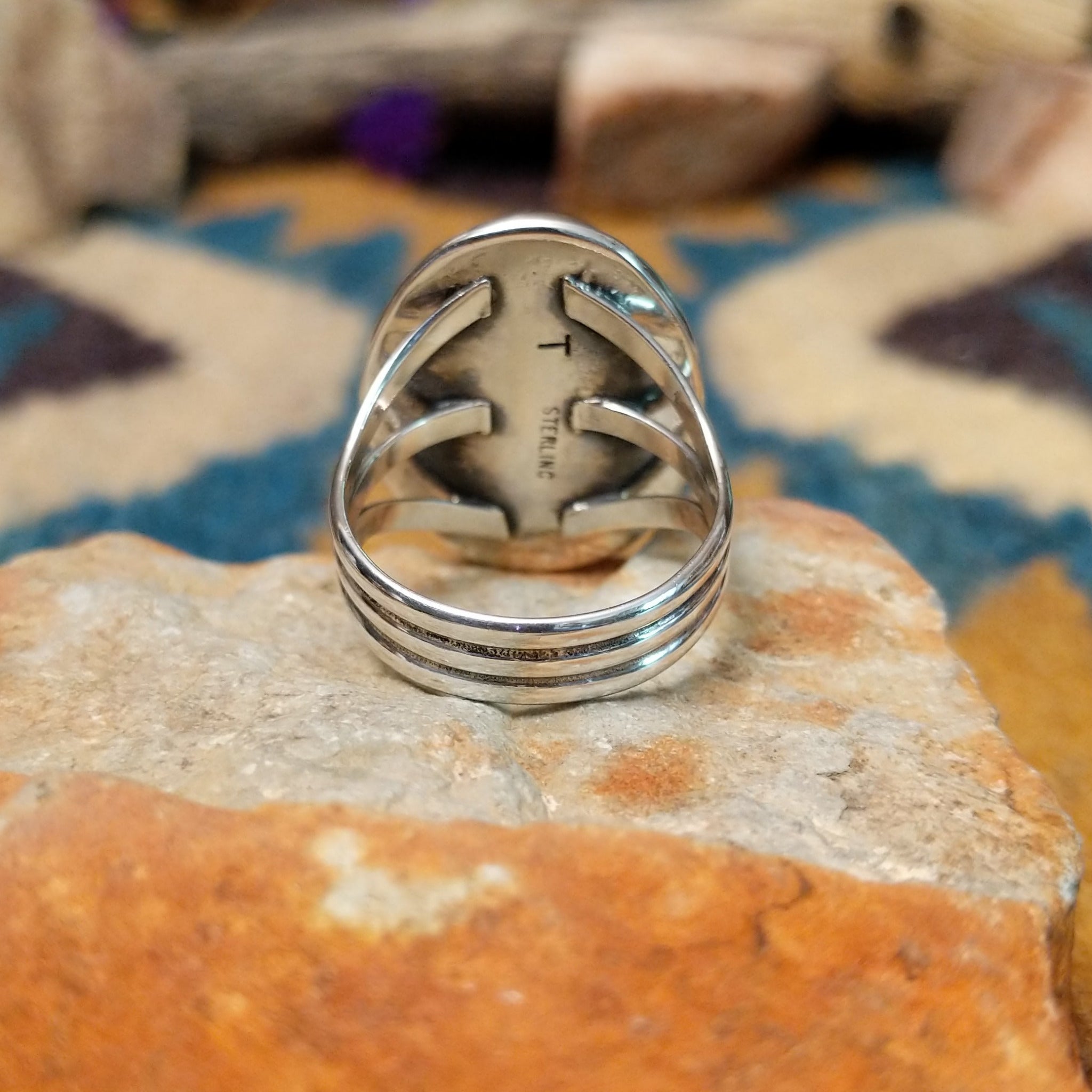 Sterling silver Malachite ring by Terry Wood featuring an oval green stone with natural banding; underside view.