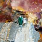 Sterling silver ring with malachite set within the bezel and layered band.