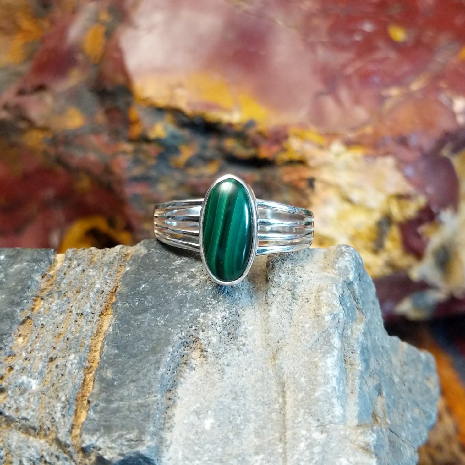 Sterling silver ring with malachite set within the bezel and layered band.