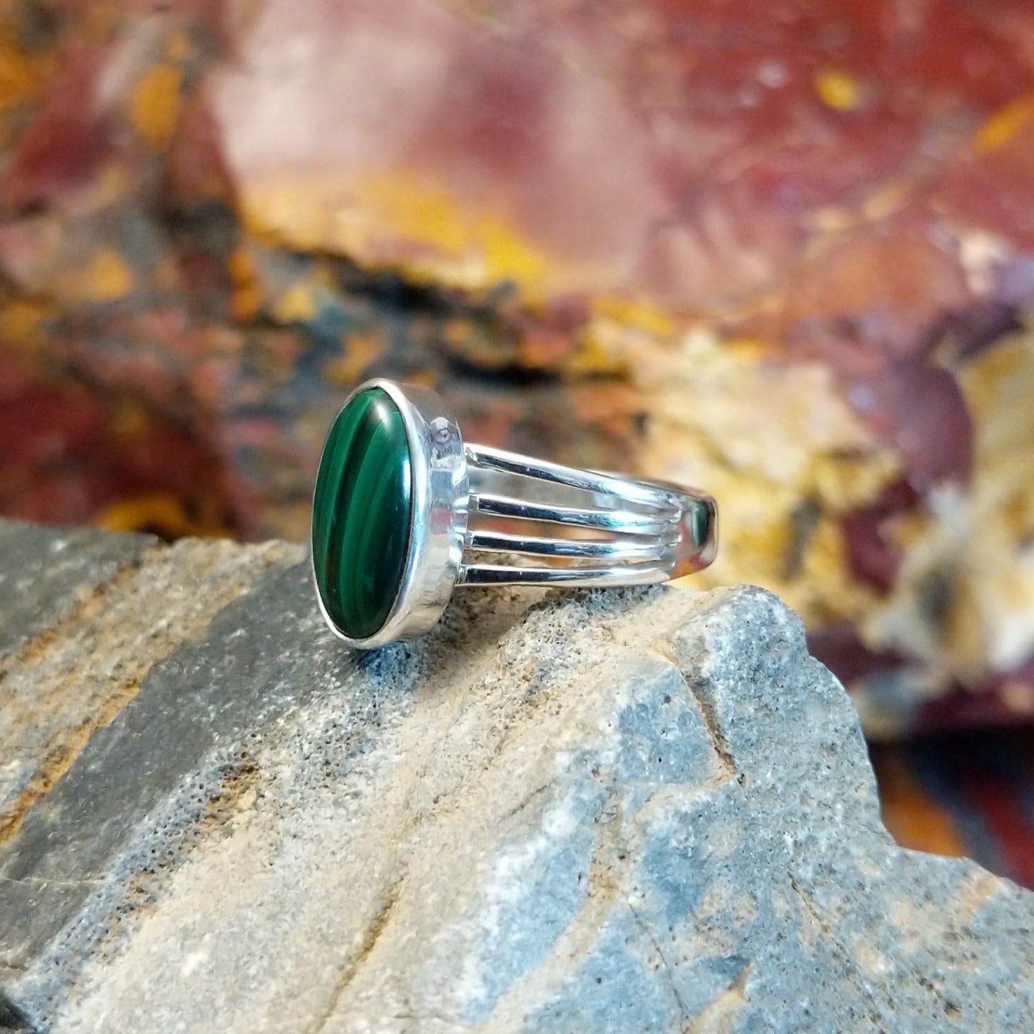 Sterling silver ring with malachite set within the bezel and layered band.