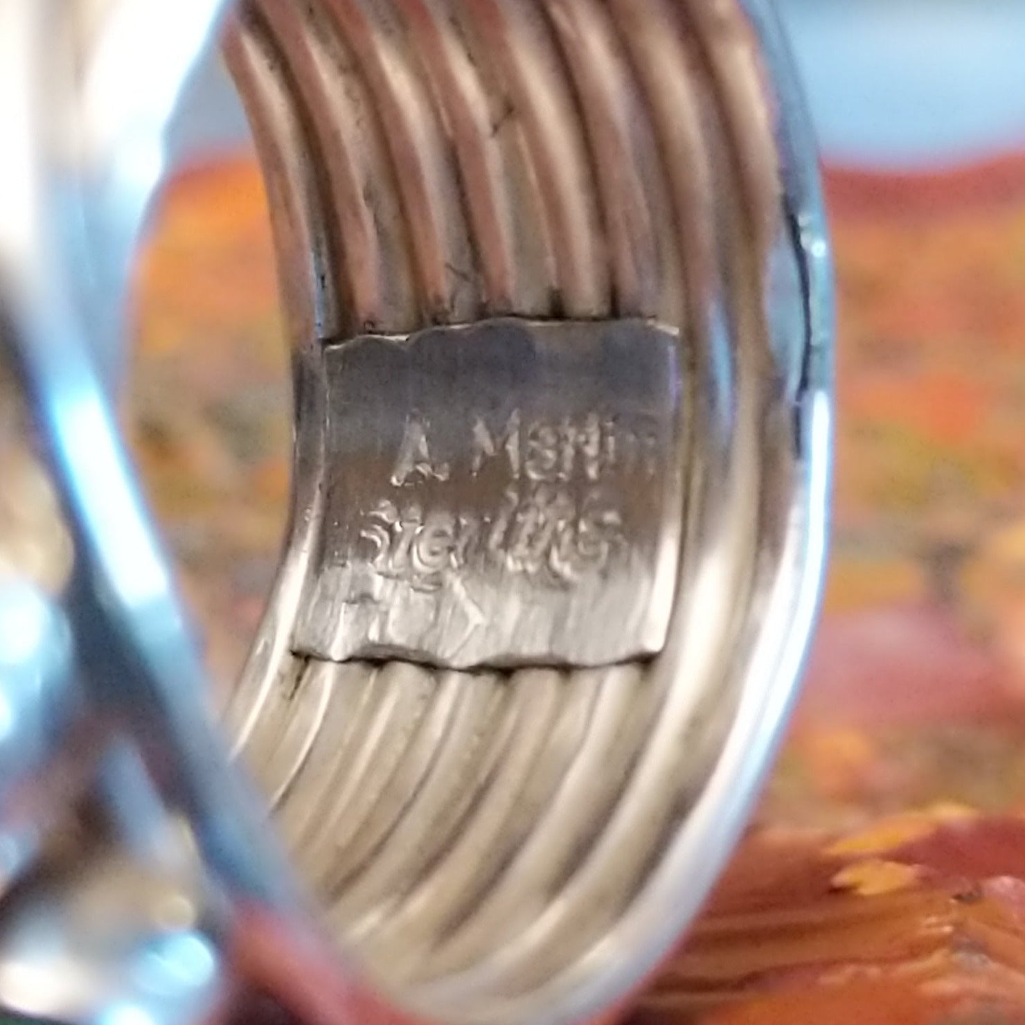 Close-up of the artisan's stamped signature.