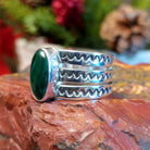 Sterling silver ring with tri-band and malachite centerpiece.