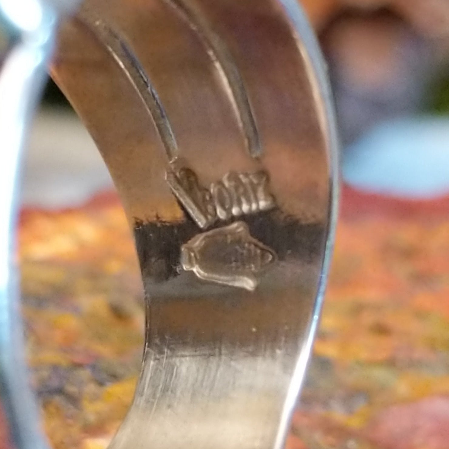 Close-up of the artisan's stamped signature.