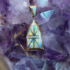 14kt gold Donald Douglas arch pendant with geometric manmade opal inlay and opal bail.