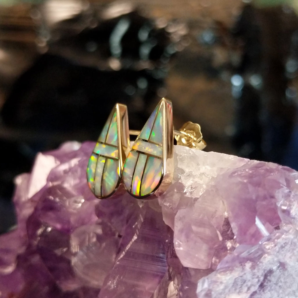 Teardrop earrings with manmade opal inlay and gold borders.