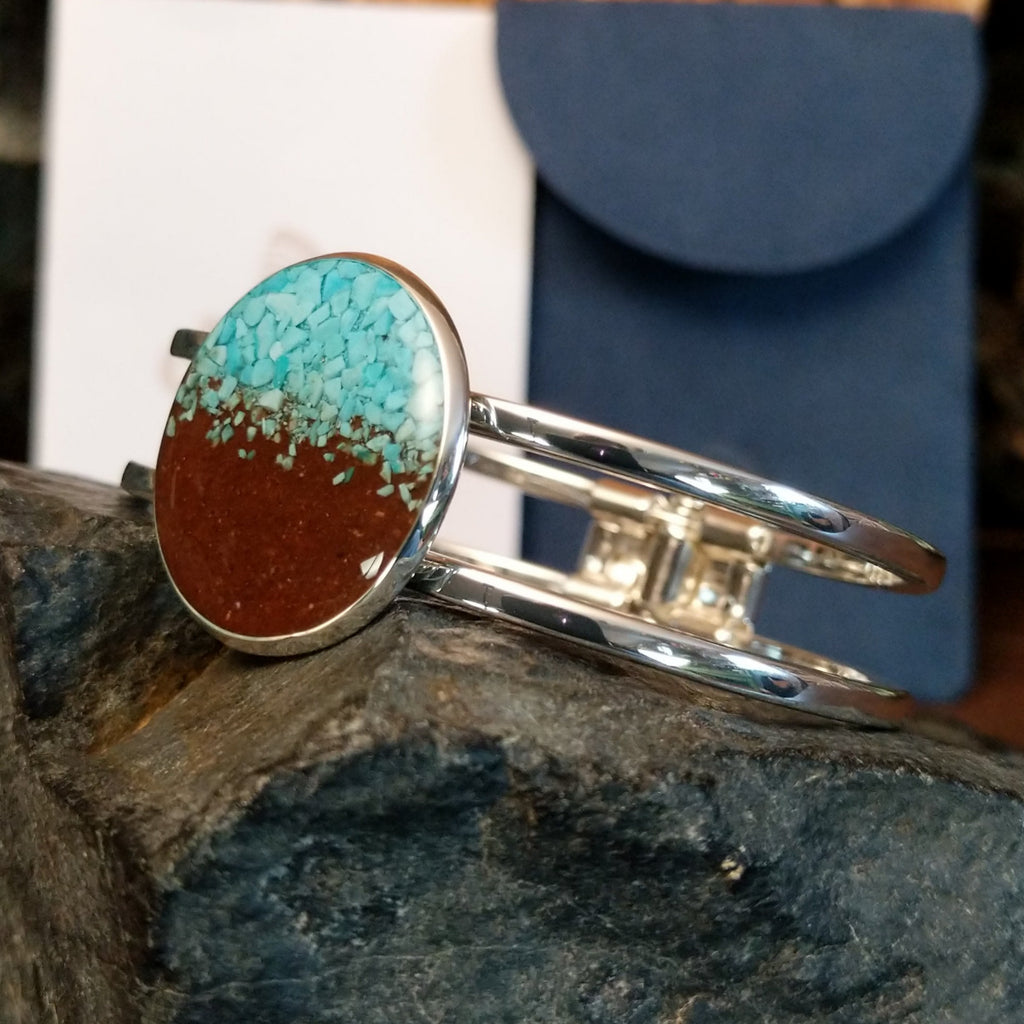 Turquoise and Lake Powell sand set in the large circular bezel of the cuff bracelet.