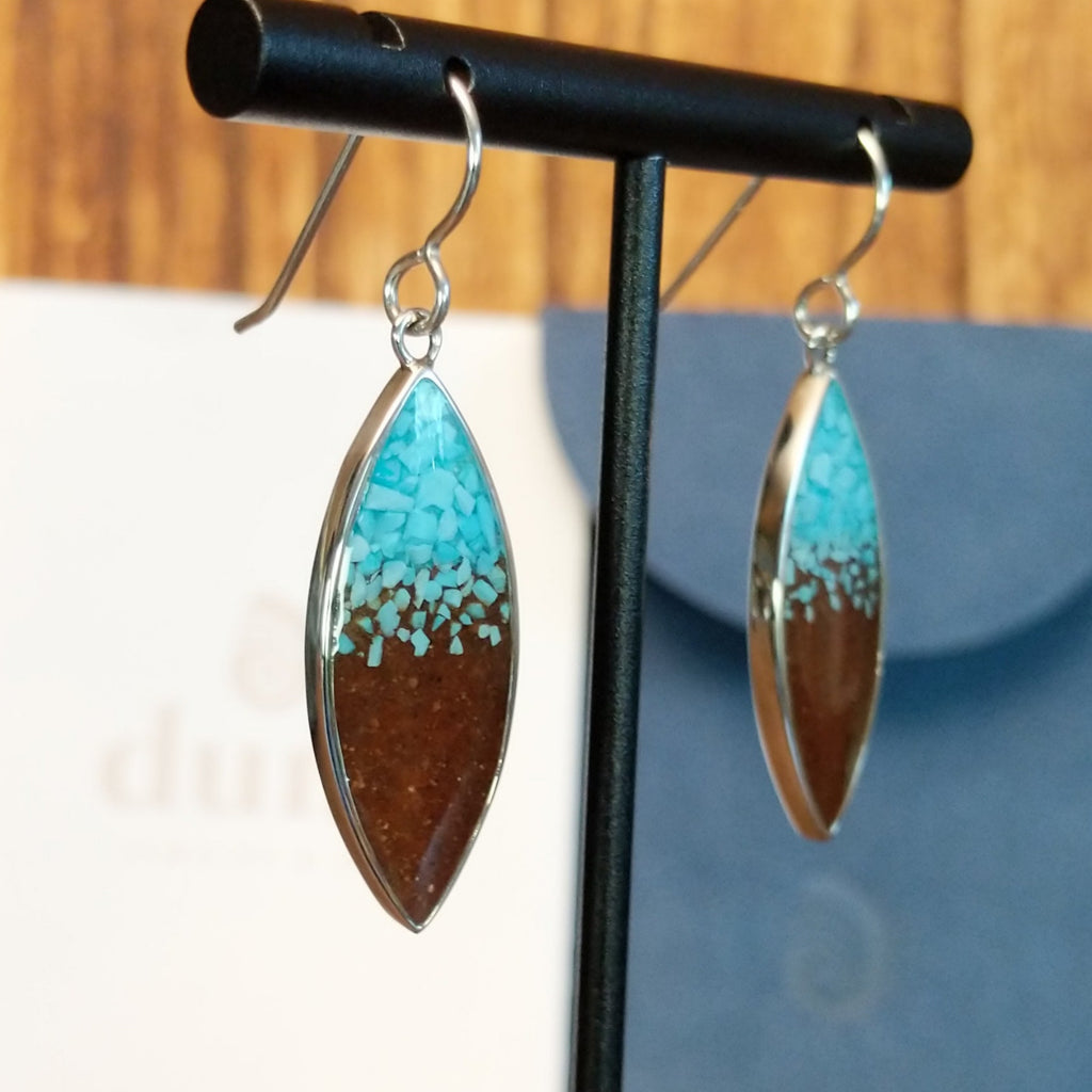 Turquoise and Lake Powell sand set in sterling silver bezels on the dangle earrings.