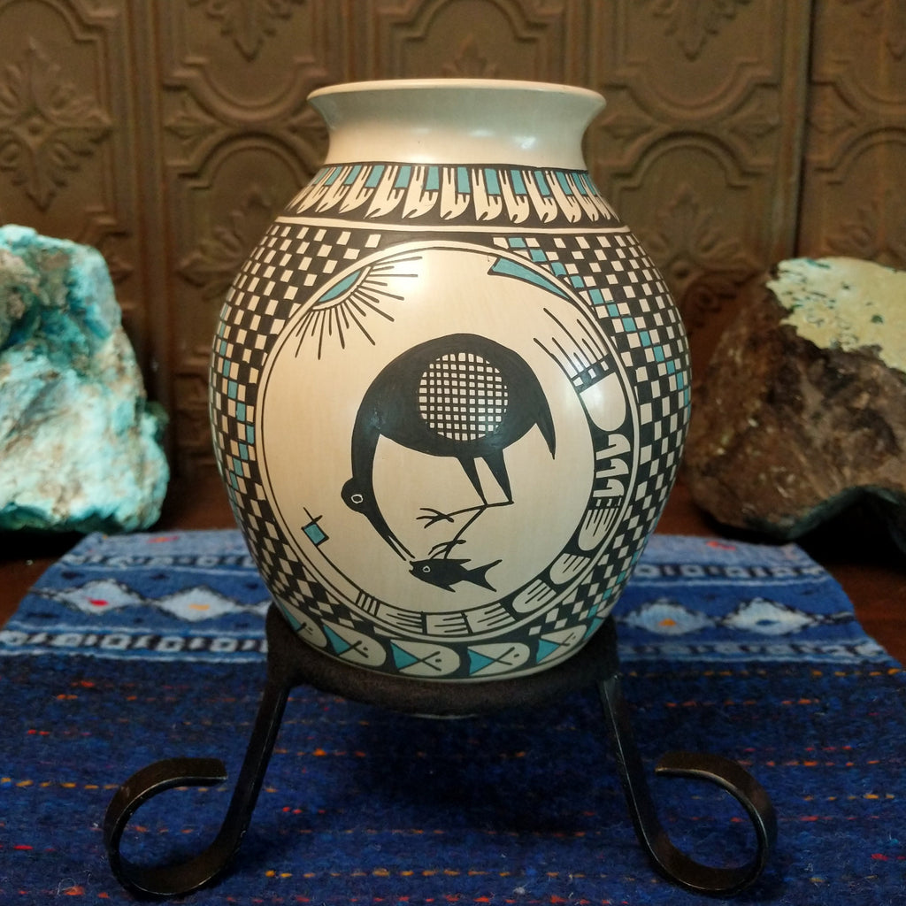 Clay pot featuring a bird and a fish.