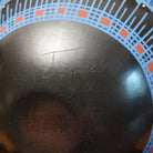 Close up of the artist's engraved signature.