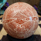 Close up of the artist's engraved signature.