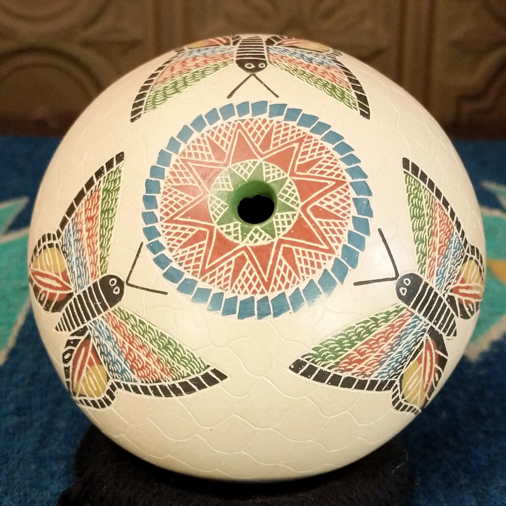 Small opening of the pot with vibrant geometric designs.