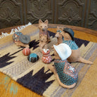 Clay sculpted into individual coyote pieces that form a nativity scene and are painted in various, colorful designs.