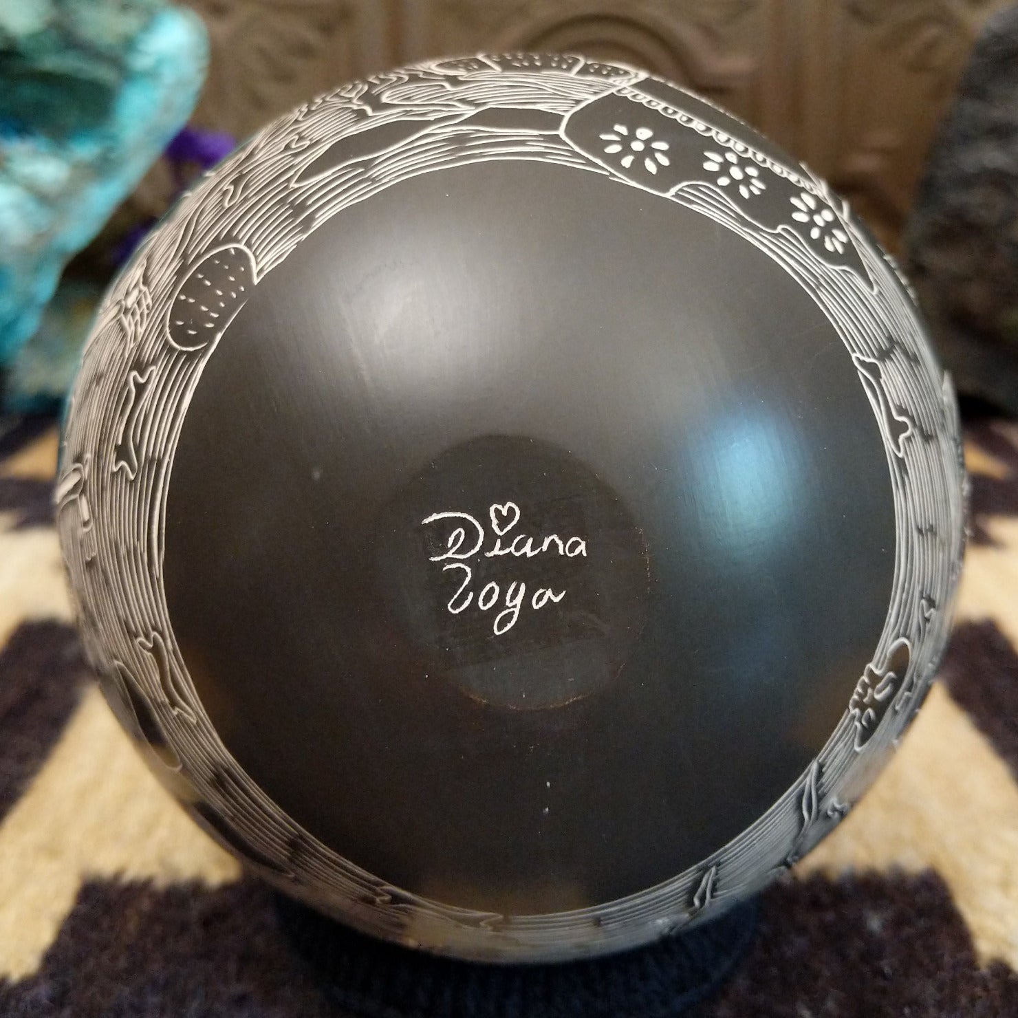 Close up of the artist's engraved signature.