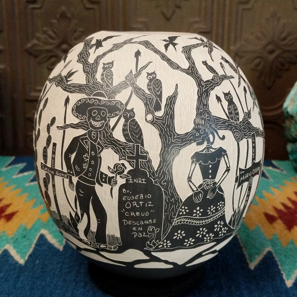Etched Day of the Dead pottery piece in the colors black and white.
