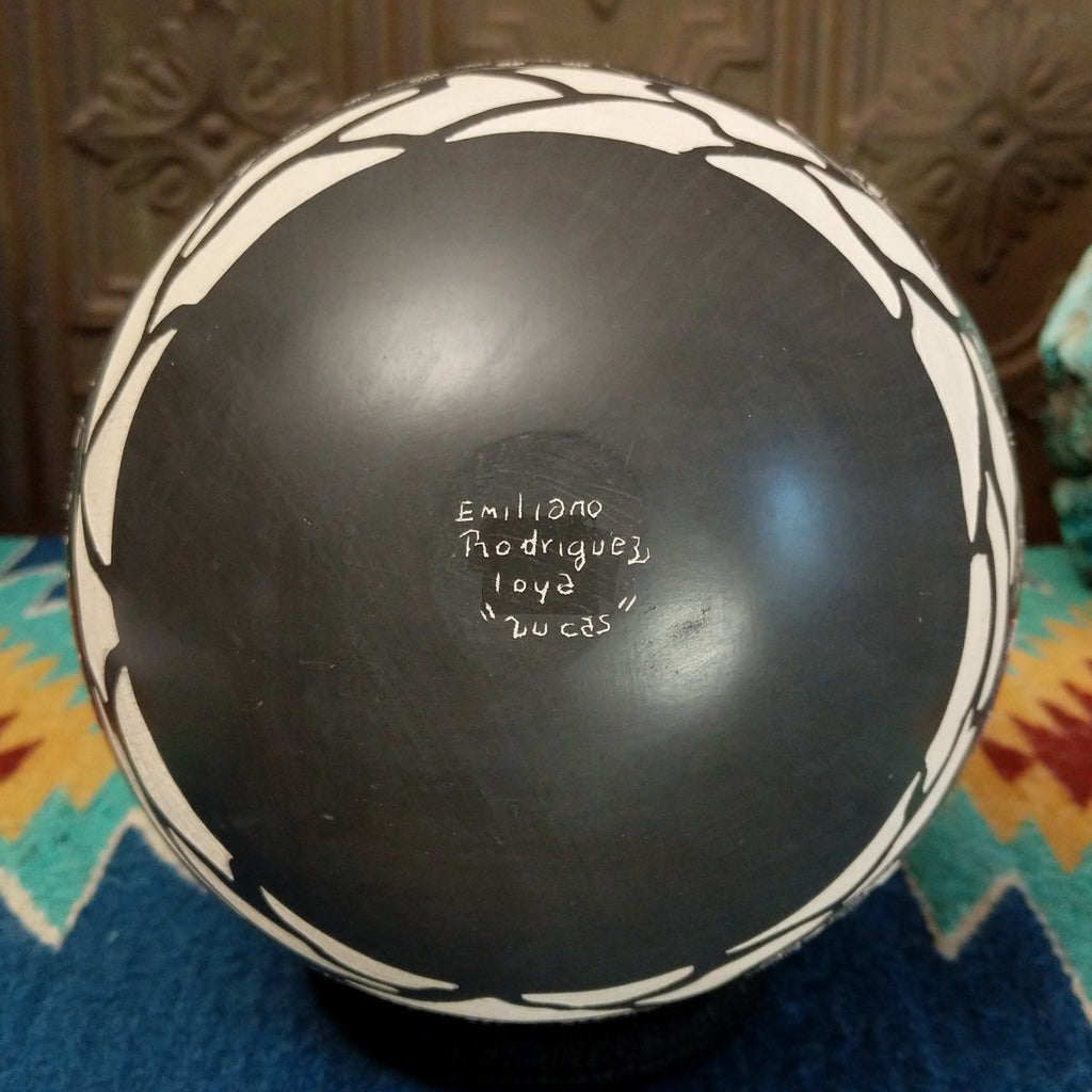 The underside is painted black with artisan's signature.