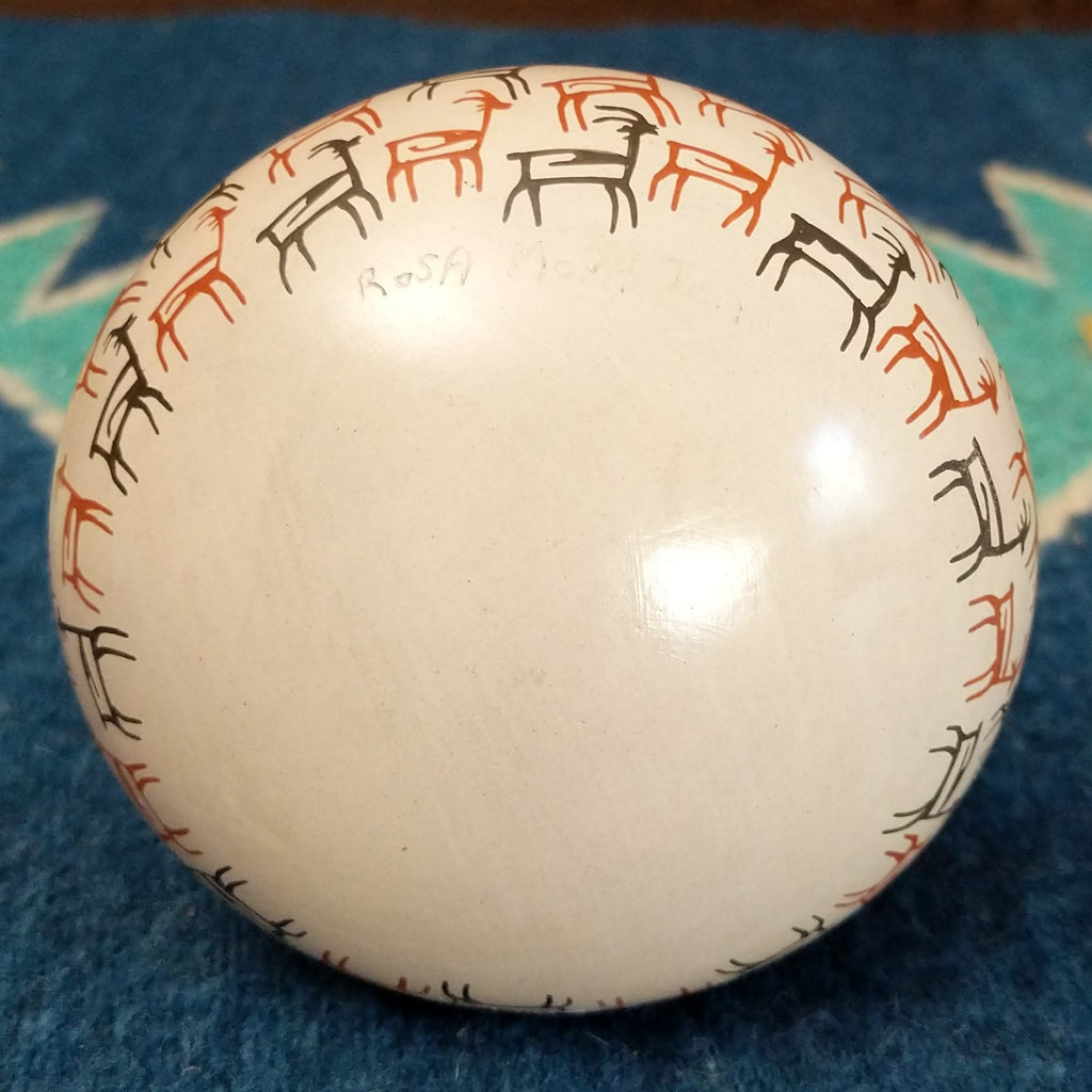 The underside of the pot features the artisan's signature.