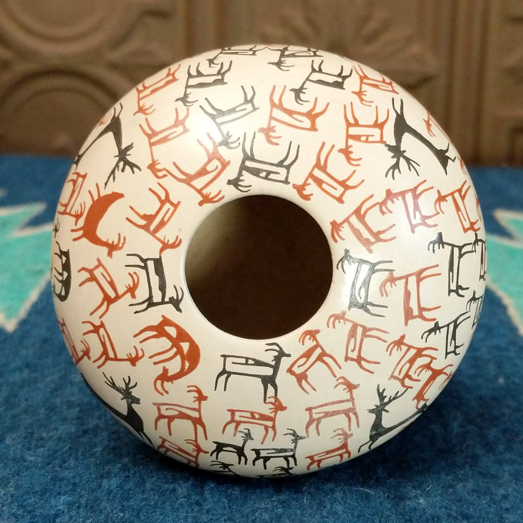 The small opening of the seed pot.