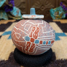 Round lidded Mata Ortiz pottery vessel featuring a dragonfly design in blue and clay tones with etched geometric background patterns.
